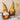 Handmade autumn gnome pair with plaid and patterned hats, yellow beards, pumpkin props