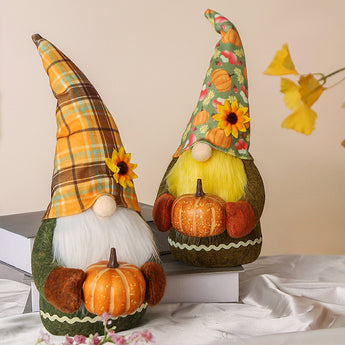 Handmade autumn gnome pair with plaid and patterned hats, yellow beards, pumpkin props