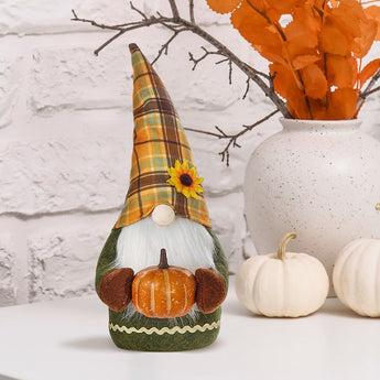 Handmade autumn harvest gnome with plaid hat, yellow flower, and pumpkin