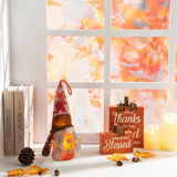 LED Thanksgiving gnome plush, glowing amber face and red leaf-pattern hat