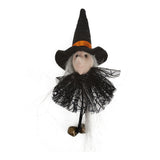Black witch doll with orange-trim hat, black tulle skirt and dangling bells