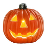 Orange LED pumpkin lantern glowing jack-o'-lantern face with black stem top