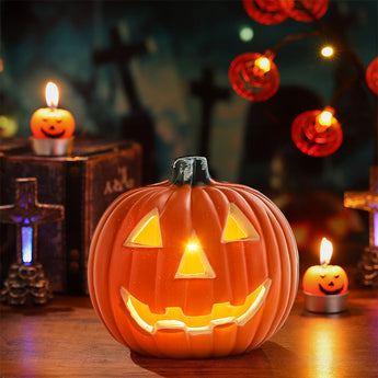 Orange LED pumpkin lantern with carved smile, warm light glowing from face cutouts