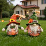 2 pack faceless gnomes standing in grass, orange and green hats with plaid outfits