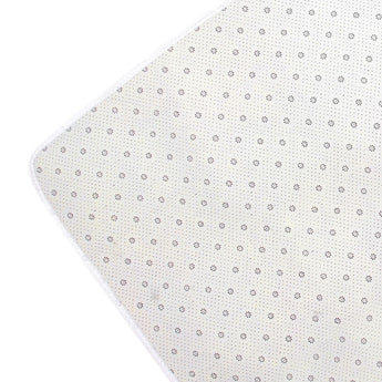 Rug backing view with light fabric and small repeating dot pattern