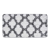 Close-up of grey-and-white geometric shag rug with quatrefoil trellis pattern