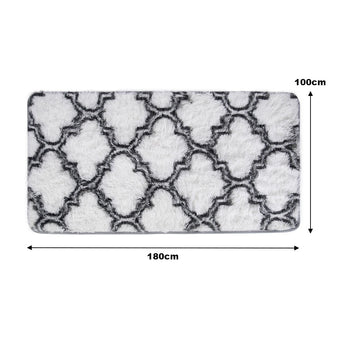 Rectangular plush area rug with gray geometric trellis on light background