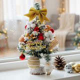 Tabletop Christmas tree with LED lights, gold bow, “Merry Christmas” banner, red and white ornaments
