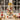 Tabletop Christmas tree with LED lights, large gold bow, red balls, gold baubles, white snow trim