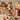 Tabletop Christmas tree with LED lights, gold bow, red and gold ornaments, white accents