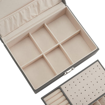 Interior of double-tier jewellery organizer with divided trays and earring board