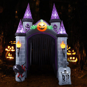 Inflatable haunted castle entrance with lit jack-o'-lantern and flaming torch lights