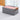 Foldable fabric organizer bin with orange handles, holding folded pastel sweaters