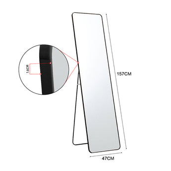 Tall rectangular floor mirror with black metal frame and slim stand, 157x47cm.