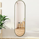 Black oval full-length wall mirror with rounded corners and arched top