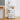 White rolling storage rack with 4 open shelves, organizing items in a narrow corner