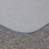 Gray PVC chair mat edge on carpet, non-slip textured surface