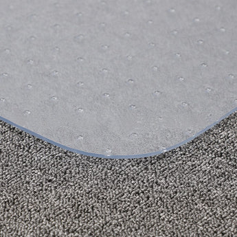 Gray PVC chair mat edge on carpet, non-slip textured surface