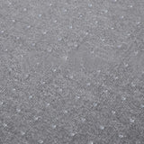 Close-up: gray non-slip PVC mat texture with raised dot pattern