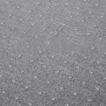 Close-up: gray non-slip PVC mat texture with raised dot pattern
