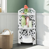 White 3-tier corner shelf cabinet with ornate cutout panels and open middle shelf