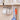 Black 6-hook rack holding mugs by handles under a cabinet bar for kitchen storage