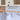 Black under-cabinet hook rack with 6 hooks, storing hanging cups and utensils