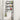 Black over-toilet storage rack with 3 shelves and towel hooks