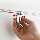 Hand pressing mounting clips on chrome wall shelf bracket