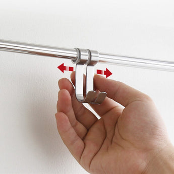 Hand pressing mounting clips on chrome wall shelf bracket