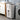 White 3-tier laundry sorter with front open bins, vented panels, rolling wheels