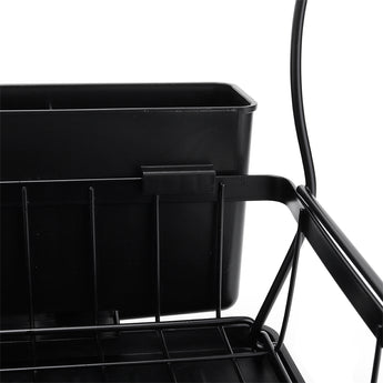 Close-up of black steel dish rack side bin and slotted draining tray