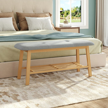 Bamboo shoe storage bench with gray upholstered top and two-tier slatted shelf
