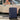 Navy hardside travel suitcase with slash texture and four spinner wheels, standing in side view