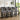 Row of dark gray velvet button-tufted wooden bar stools with nailhead trim and arched backs