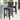 Dark gray velvet button-tufted wooden bar stool with arched back and nailhead trim