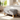 Light grey linen upholstered ottoman footstool with hinged top and hidden storage