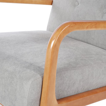 Wooden armrest and grey linen seat cushion on tufted armchair, close-up detail.