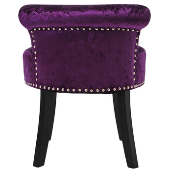 Dark purple velvet dressing stool with studded front band, rounded back, and black legs