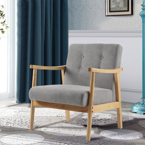 Upholstered armchair with grey fabric seat and back, button tufting, and light wood legs
