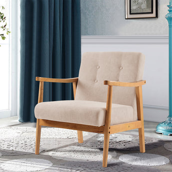 Upholstered armchair with beige fabric seat and back, button tufting, and light wood legs