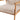 Close-up of beige upholstered armchair seat cushion and armrest with light wood frame