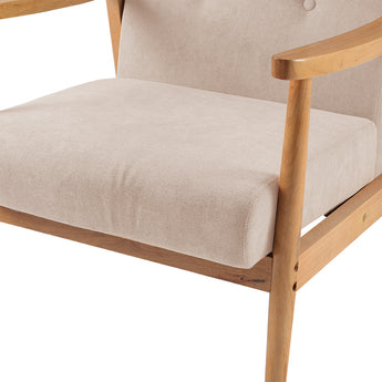 Close-up of beige upholstered armchair seat cushion and armrest with light wood frame