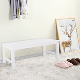 White pine bench with flat top and open side frames, supported by sturdy legs