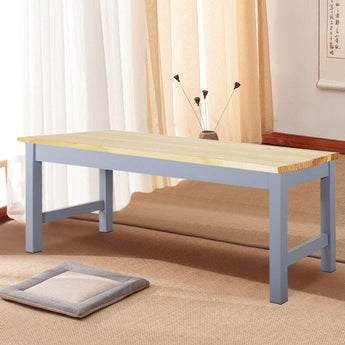 Pine wood bench with light pine tabletop and gray-blue cross-brace ends.
