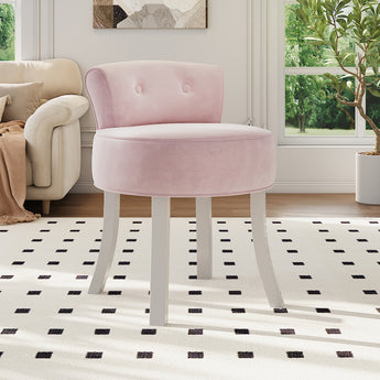 Light pink velvet vanity chair with padded rounded seat, button-tufted back, and white legs