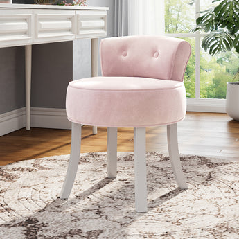 Light pink velvet dressing stool chair with curved seat, button-tufted back, and white legs