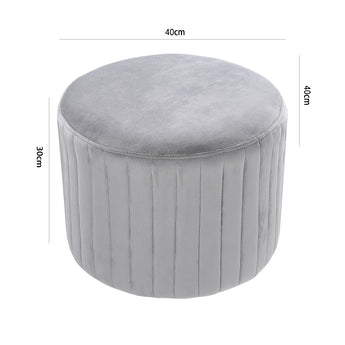 Light gray round velvet ottoman pouf with vertical channel stitching and round top
