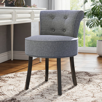 Grey linen vanity stool with black wooden legs, tufted back, round padded seat