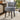 Grey linen vanity stool with tufted back and round seat, black wooden legs